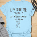 This Life Is Better With A Frenchie Or Two t-shirt is made for French Bulldog lovers who know one Frenchie is wonderful, but two is even better. Featuring a simple Frenchie illustration with clean mixed typography, this design has a sweet, easy-to-wear dog-parent feel for everyday style. Perfect for Frenchie moms, Frenchie dads, French Bulldog owners, rescue dog lovers, and anyone whose life is happier with a little Frenchie chaos.