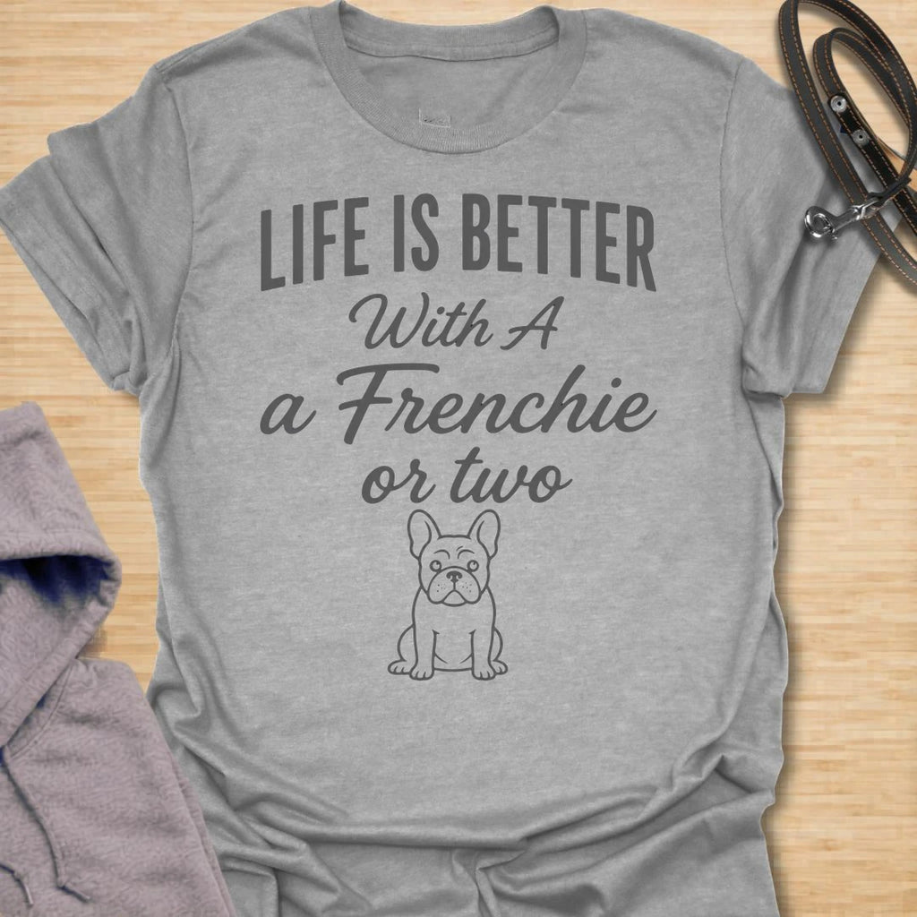 This Life Is Better With A Frenchie Or Two t-shirt is made for French Bulldog lovers who know one Frenchie is wonderful, but two is even better. Featuring a simple Frenchie illustration with clean mixed typography, this design has a sweet, easy-to-wear dog-parent feel for everyday style. Perfect for Frenchie moms, Frenchie dads, French Bulldog owners, rescue dog lovers, and anyone whose life is happier with a little Frenchie chaos.