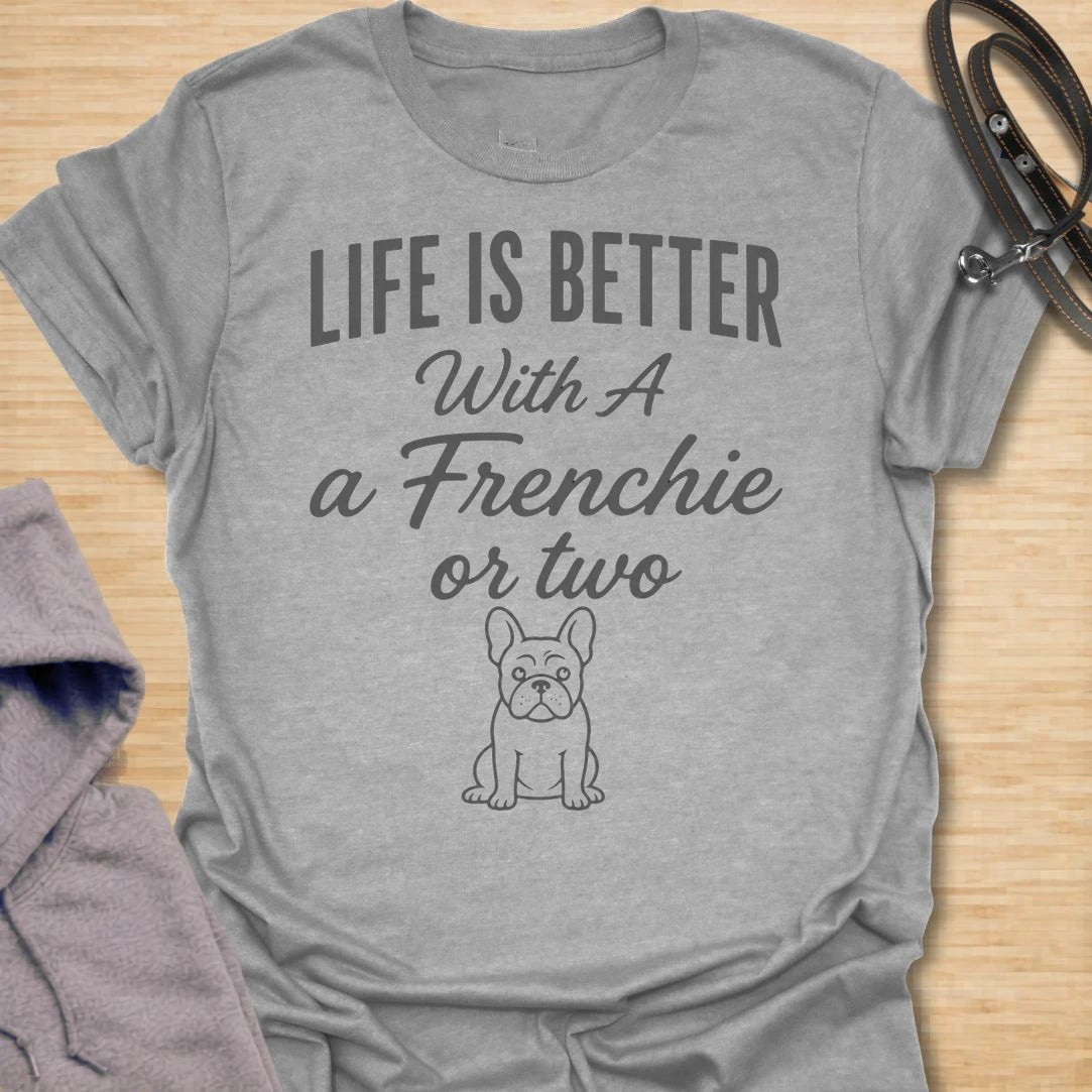 This Life Is Better With A Frenchie Or Two t-shirt is made for French Bulldog lovers who know one Frenchie is wonderful, but two is even better. Featuring a simple Frenchie illustration with clean mixed typography, this design has a sweet, easy-to-wear dog-parent feel for everyday style. Perfect for Frenchie moms, Frenchie dads, French Bulldog owners, rescue dog lovers, and anyone whose life is happier with a little Frenchie chaos.