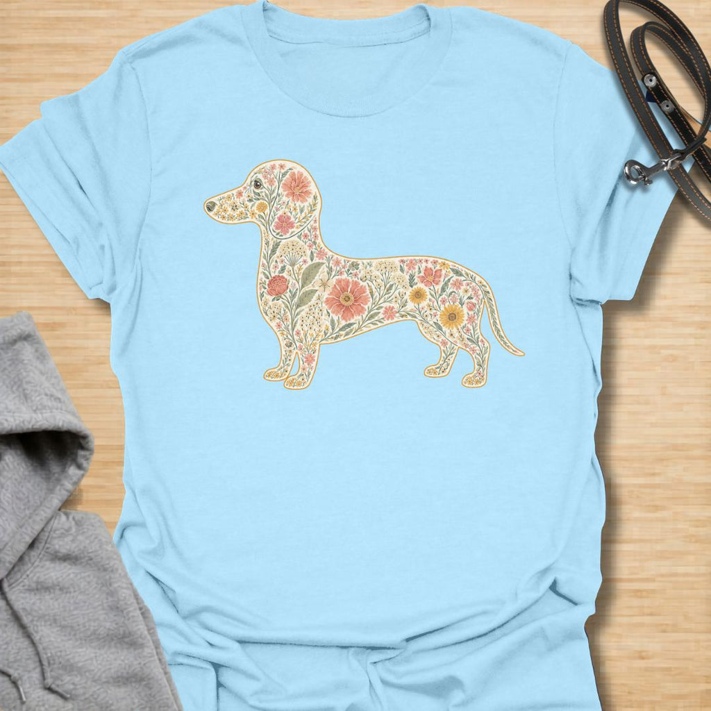 This Floral Dachshund t-shirt is made for doxie lovers who want a beautiful, botanical take on their favorite long dog. Featuring a dachshund silhouette filled with intricate flowers, leaves, vines, and vintage-style floral details, this design blends dog-lover charm with soft garden-inspired artwork. Perfect for dachshund moms, dachshund dads, wiener dog lovers, sausage dog fans, botanical art lovers, and anyone who loves both dogs and flowers.