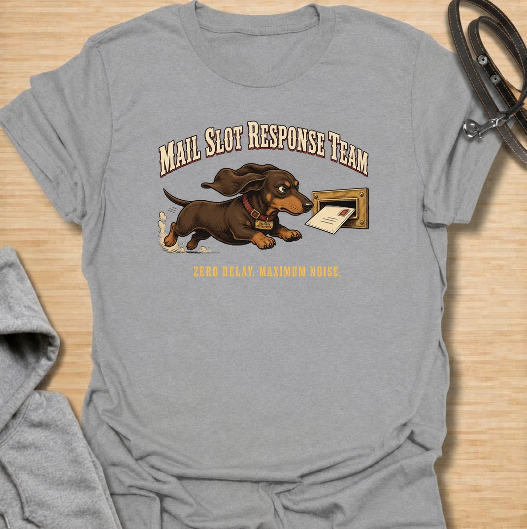 Zero delay and maximum noise. A funny dachshund T-shirt for sausage dogs who respond to every letter like a household emergency.