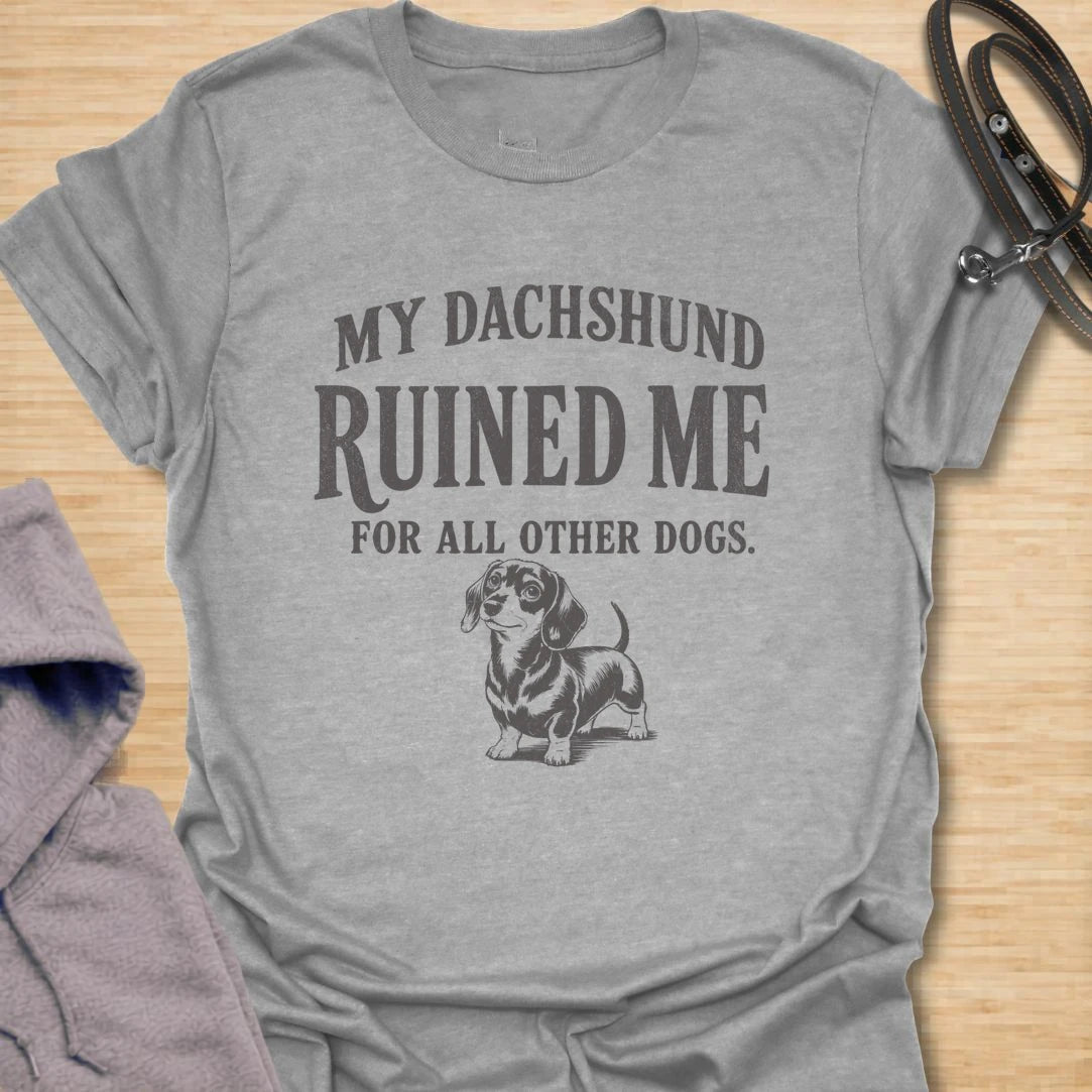 This My Dachshund Ruined Me For All Other Dogs t-shirt is made for doxie lovers who know once you love a dachshund, no other dog quite compares. Featuring bold vintage-style typography and a cute dachshund illustration, this design has a funny, loyal dog-parent feel that wiener dog fans will instantly understand. Perfect for dachshund moms, dachshund dads, doxie owners, rescue dog lovers, and anyone completely devoted to their little long dog.