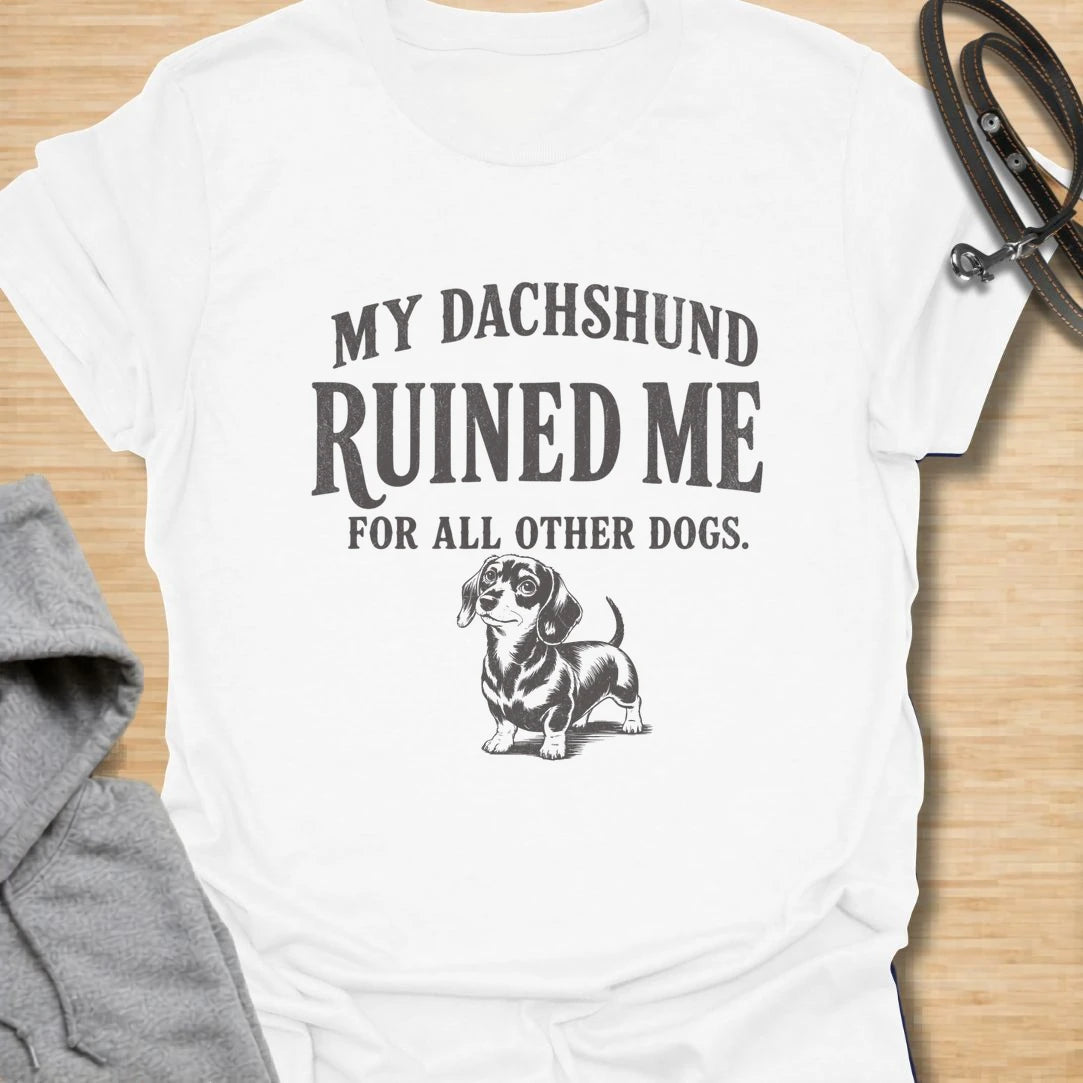 This My Dachshund Ruined Me For All Other Dogs t-shirt is made for doxie lovers who know once you love a dachshund, no other dog quite compares. Featuring bold vintage-style typography and a cute dachshund illustration, this design has a funny, loyal dog-parent feel that wiener dog fans will instantly understand. Perfect for dachshund moms, dachshund dads, doxie owners, rescue dog lovers, and anyone completely devoted to their little long dog.