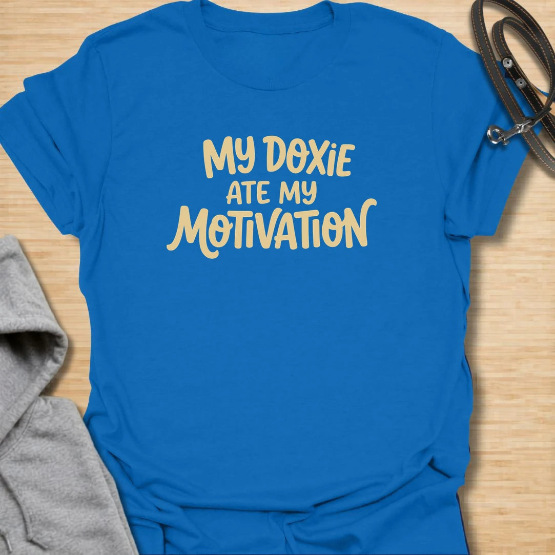 Doxie Motivation t-shirt for dachshund lovers who blame their sausage dog for every lazy day, missed chore, and cozy nap. The playful text reads “My Doxie Ate My Motivation,” making it a funny choice for doxie moms, dog owners, and anyone whose dachshund runs the household. A relatable gift for dog people with a lazy little sidekick.