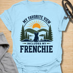 This My Favorite View Includes My Frenchie t-shirt is made for French Bulldog lovers who know every beautiful view is better with their little dog beside them. Featuring a scenic outdoor badge with mountains, pine trees, a sunset, and a seated Frenchie silhouette, this design has a warm adventure-inspired feel with breed-specific charm. Perfect for Frenchie moms, Frenchie dads, French Bulldog owners, outdoor dog lovers, hikers, campers, and anyone whose favorite view always includes their dog.