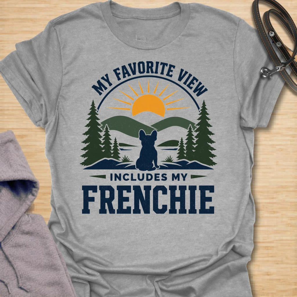 This My Favorite View Includes My Frenchie t-shirt is made for French Bulldog lovers who know every beautiful view is better with their little dog beside them. Featuring a scenic outdoor badge with mountains, pine trees, a sunset, and a seated Frenchie silhouette, this design has a warm adventure-inspired feel with breed-specific charm. Perfect for Frenchie moms, Frenchie dads, French Bulldog owners, outdoor dog lovers, hikers, campers, and anyone whose favorite view always includes their dog.