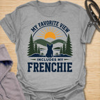 This My Favorite View Includes My Frenchie t-shirt is made for French Bulldog lovers who know every beautiful view is better with their little dog beside them. Featuring a scenic outdoor badge with mountains, pine trees, a sunset, and a seated Frenchie silhouette, this design has a warm adventure-inspired feel with breed-specific charm. Perfect for Frenchie moms, Frenchie dads, French Bulldog owners, outdoor dog lovers, hikers, campers, and anyone whose favorite view always includes their dog.