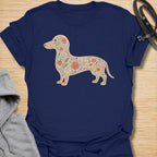 This Floral Dachshund t-shirt is made for doxie lovers who want a beautiful, botanical take on their favorite long dog. Featuring a dachshund silhouette filled with intricate flowers, leaves, vines, and vintage-style floral details, this design blends dog-lover charm with soft garden-inspired artwork. Perfect for dachshund moms, dachshund dads, wiener dog lovers, sausage dog fans, botanical art lovers, and anyone who loves both dogs and flowers.