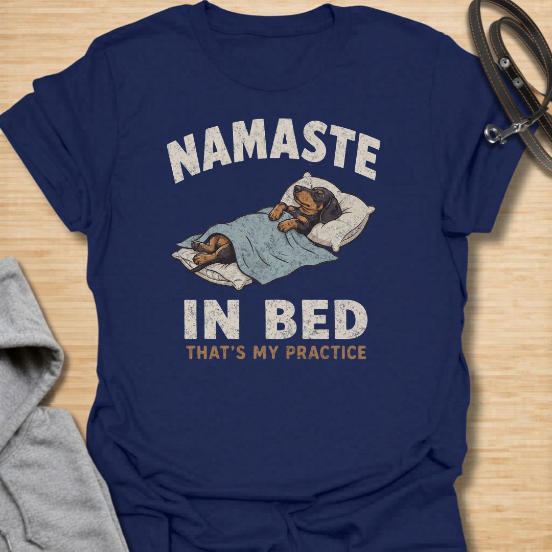Celebrate the dachshund approach to yoga with this funny “Namaste in Bed” T-shirt. Featuring a cozy sausage dog tucked beneath the blankets with the phrase “That’s My Practice,” it is perfect for dachshund moms, dog dads, homebodies, and yoga lovers. A playful gift for anyone who prefers relaxation, naps, and staying comfortably in bed.