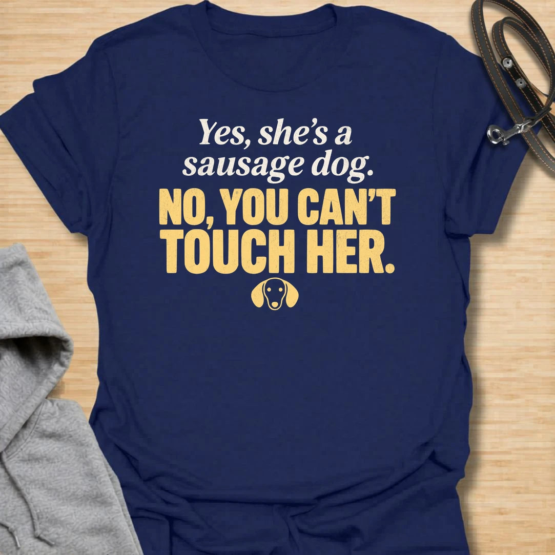 This No You Can’t Touch Her t-shirt is made for dachshund lovers who know their little sausage dog may be cute, but personal space is non-negotiable. Featuring bold text-only typography, a small dachshund face icon, and a funny protective dog-parent message, this design has a simple, attitude-filled feel that doxie owners will instantly understand. Perfect for dachshund moms, dachshund dads, wiener dog fans, rescue dog lovers, anxious dog owners, and anyone whose tiny long dog chooses who gets close.