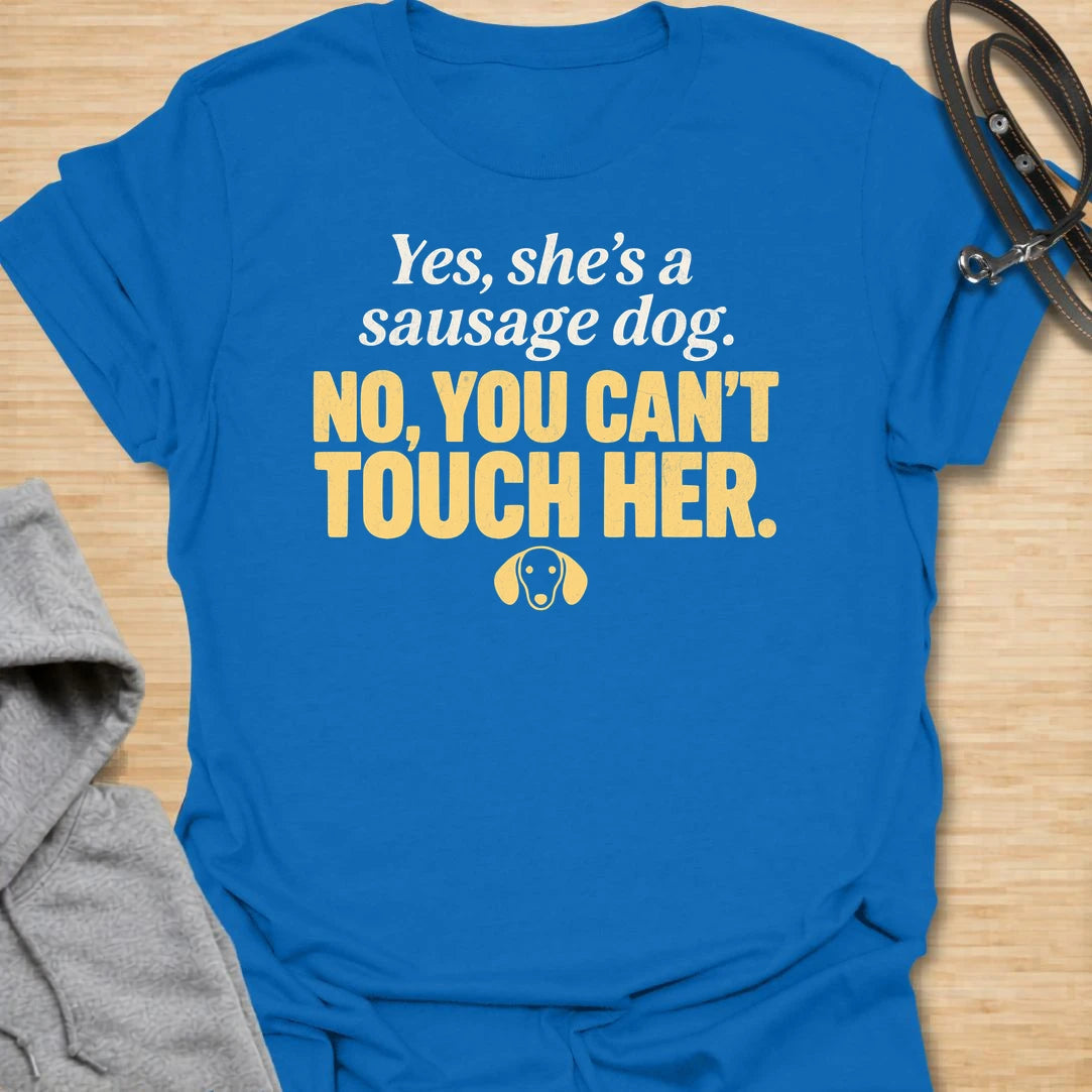 This No You Can’t Touch Her t-shirt is made for dachshund lovers who know their little sausage dog may be cute, but personal space is non-negotiable. Featuring bold text-only typography, a small dachshund face icon, and a funny protective dog-parent message, this design has a simple, attitude-filled feel that doxie owners will instantly understand. Perfect for dachshund moms, dachshund dads, wiener dog fans, rescue dog lovers, anxious dog owners, and anyone whose tiny long dog chooses who gets close.