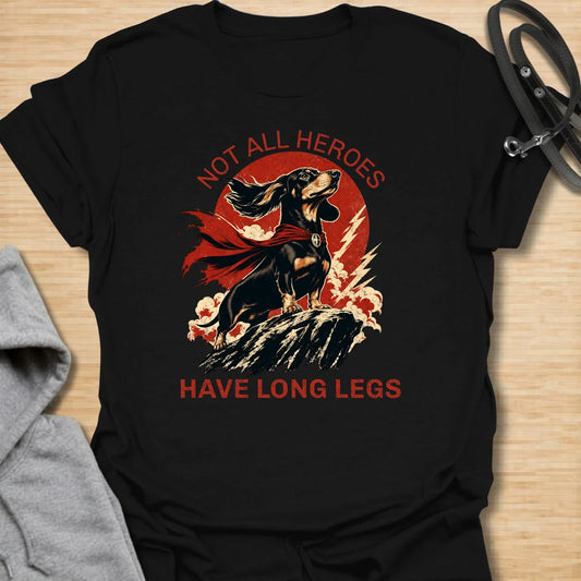 Not All Heroes Have Long Legs dachshund t-shirt for anyone who knows a sausage dog can still save the day. This bold comic-style design features a heroic dachshund with dramatic movement and strong vintage lettering. It is a fun gift for dachshund owners, doxie lovers, and wiener dog fans. Perfect for people who believe tiny legs can still carry a lot of personality.