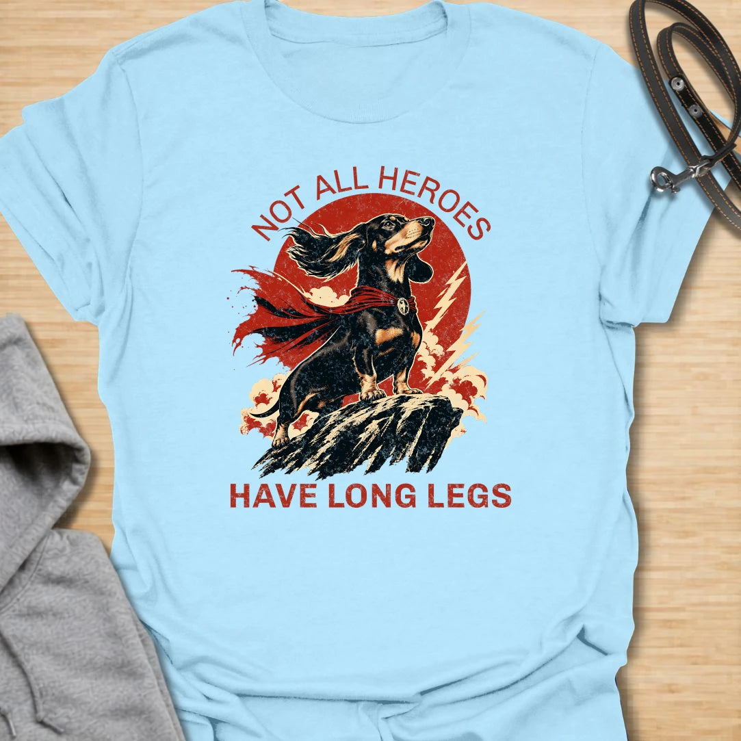 Not All Heroes Have Long Legs dachshund t-shirt for anyone who knows a sausage dog can still save the day. This bold comic-style design features a heroic dachshund with dramatic movement and strong vintage lettering. It is a fun gift for dachshund owners, doxie lovers, and wiener dog fans. Perfect for people who believe tiny legs can still carry a lot of personality.