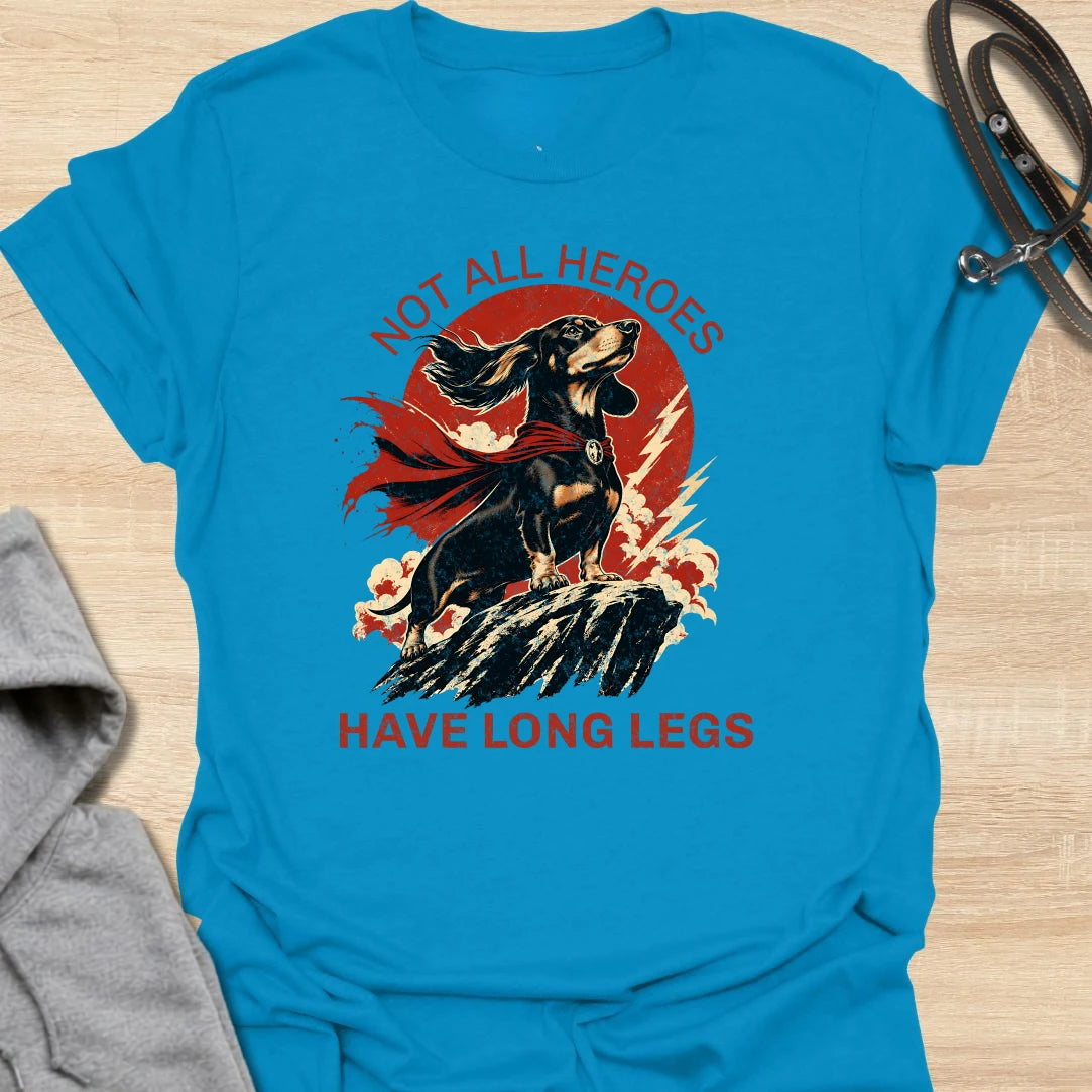 Not All Heroes Have Long Legs dachshund t-shirt for anyone who knows a sausage dog can still save the day. This bold comic-style design features a heroic dachshund with dramatic movement and strong vintage lettering. It is a fun gift for dachshund owners, doxie lovers, and wiener dog fans. Perfect for people who believe tiny legs can still carry a lot of personality.