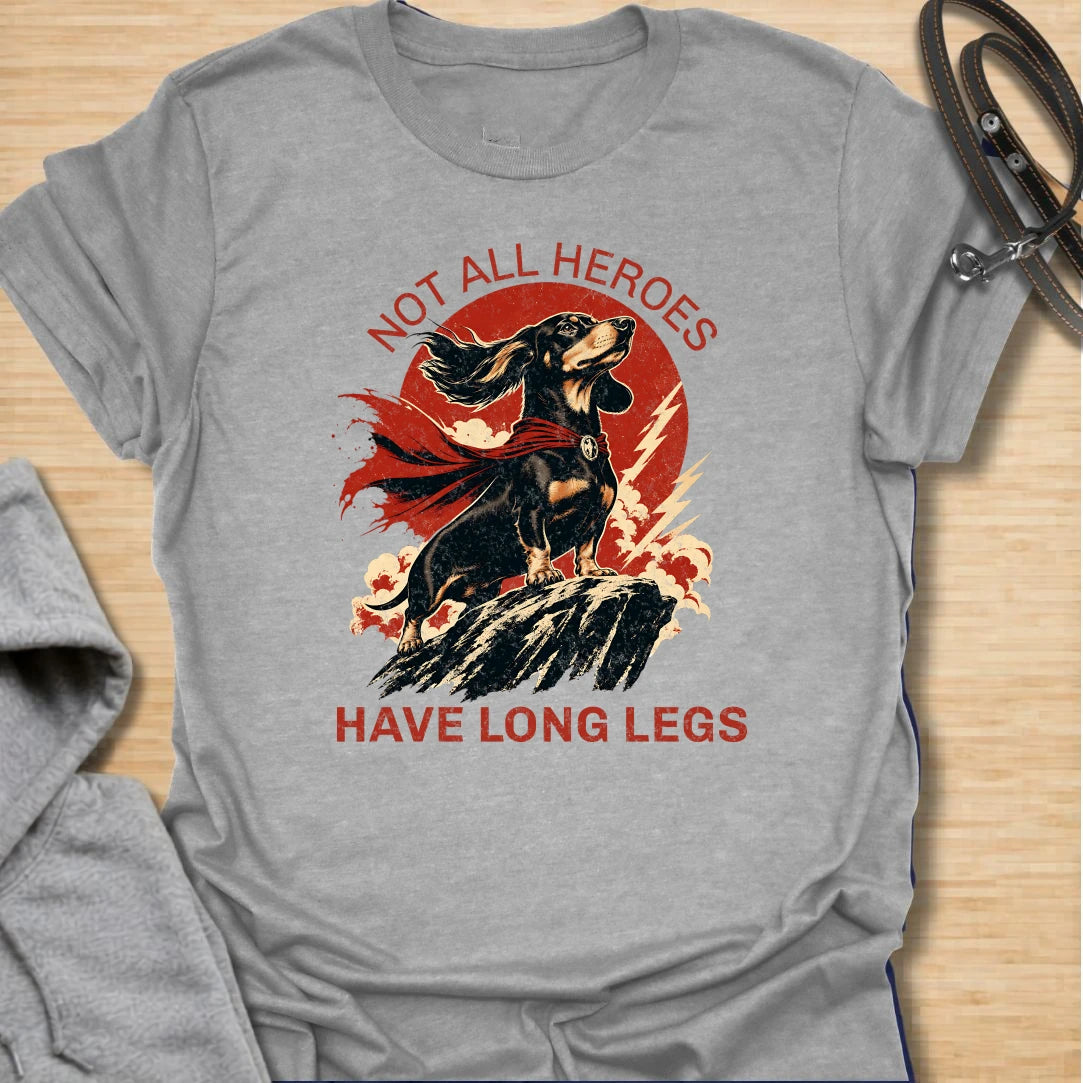 Not All Heroes Have Long Legs dachshund t-shirt for anyone who knows a sausage dog can still save the day. This bold comic-style design features a heroic dachshund with dramatic movement and strong vintage lettering. It is a fun gift for dachshund owners, doxie lovers, and wiener dog fans. Perfect for people who believe tiny legs can still carry a lot of personality.