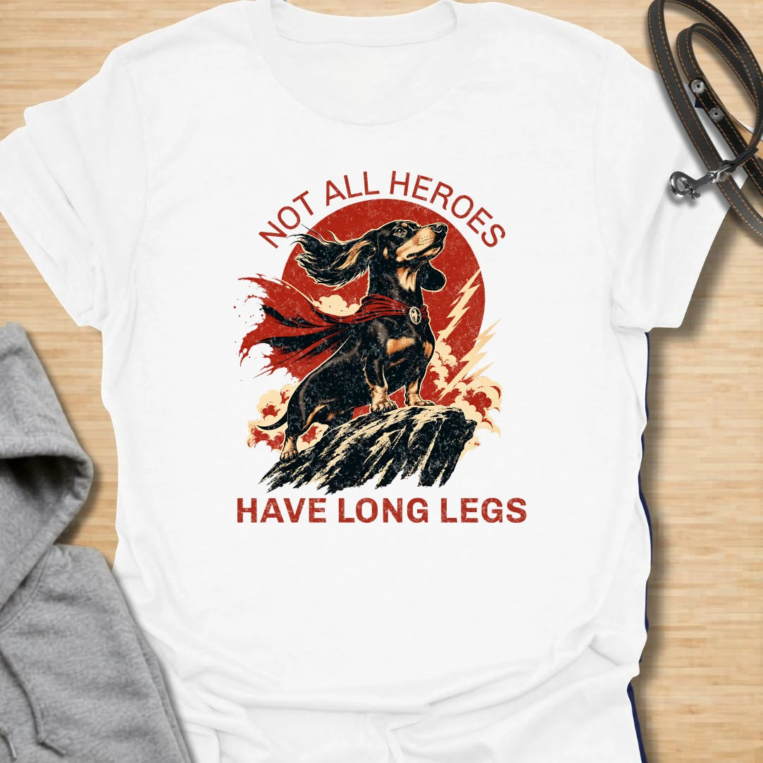 Not All Heroes Have Long Legs dachshund t-shirt for anyone who knows a sausage dog can still save the day. This bold comic-style design features a heroic dachshund with dramatic movement and strong vintage lettering. It is a fun gift for dachshund owners, doxie lovers, and wiener dog fans. Perfect for people who believe tiny legs can still carry a lot of personality.