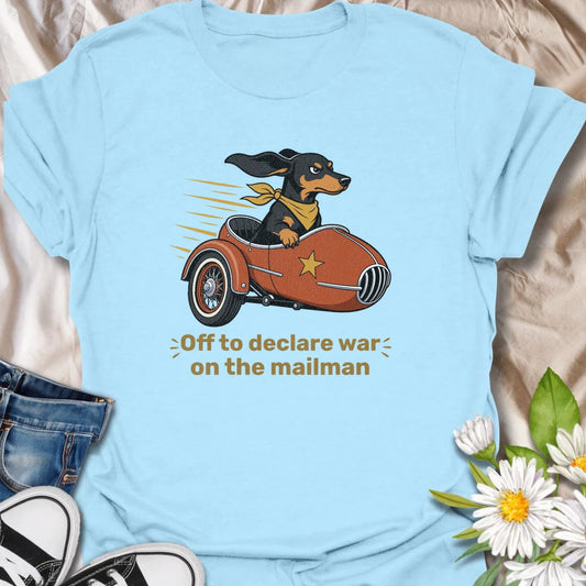 Your dachshund is off to defend the household from its most persistent visitor: the mailman. This funny T-shirt features a determined sausage dog heading into action in a vintage sidecar. A playful gift for dachshund owners familiar with daily barking, window patrol, and dramatic home security.