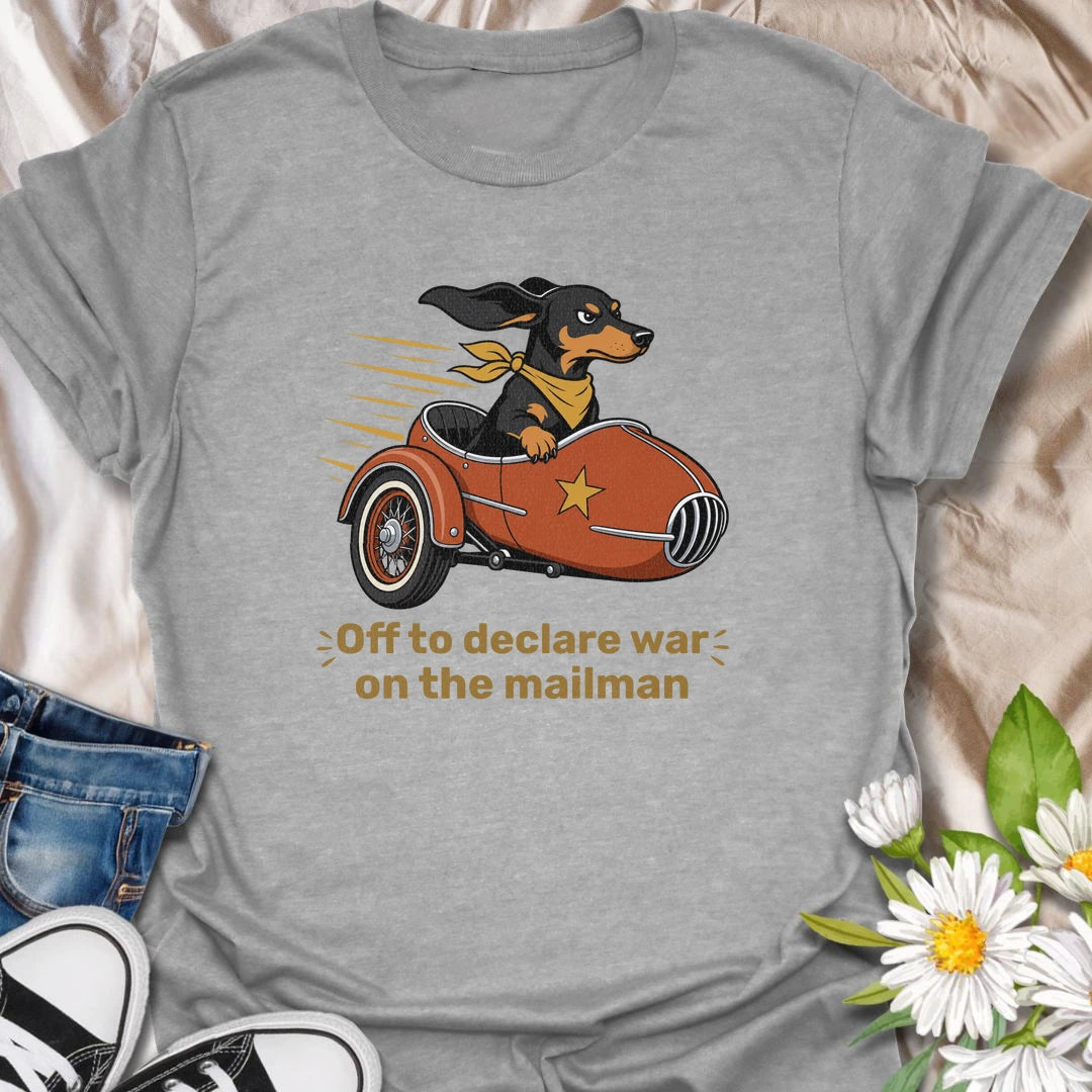 Your dachshund is off to defend the household from its most persistent visitor: the mailman. This funny T-shirt features a determined sausage dog heading into action in a vintage sidecar. A playful gift for dachshund owners familiar with daily barking, window patrol, and dramatic home security.