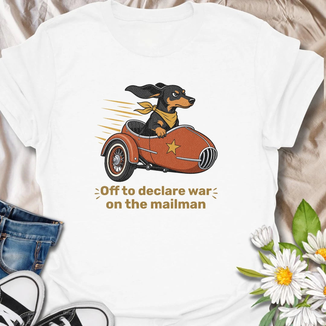 Your dachshund is off to defend the household from its most persistent visitor: the mailman. This funny T-shirt features a determined sausage dog heading into action in a vintage sidecar. A playful gift for dachshund owners familiar with daily barking, window patrol, and dramatic home security.