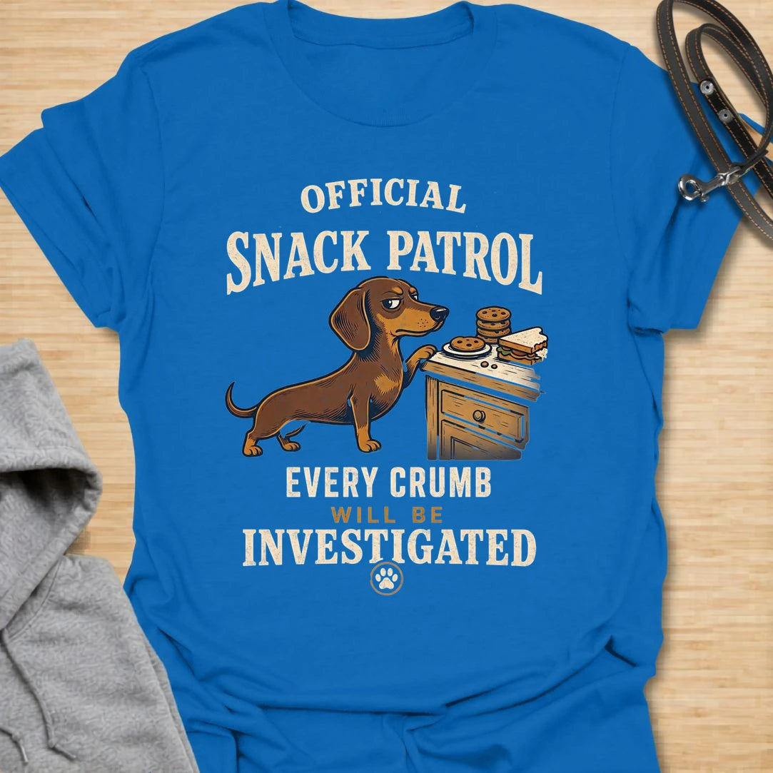 This Official Snack Patrol t-shirt is made for dachshund lovers who know no crumb, snack, or unattended plate is ever truly safe. Featuring a determined doxie investigating a bedside table full of treats with bold vintage-style text, this funny dog design is great for dachshund moms, dachshund dads, wiener dog fans, rescue dog lovers, and anyone whose little long dog takes snack supervision very seriously.
