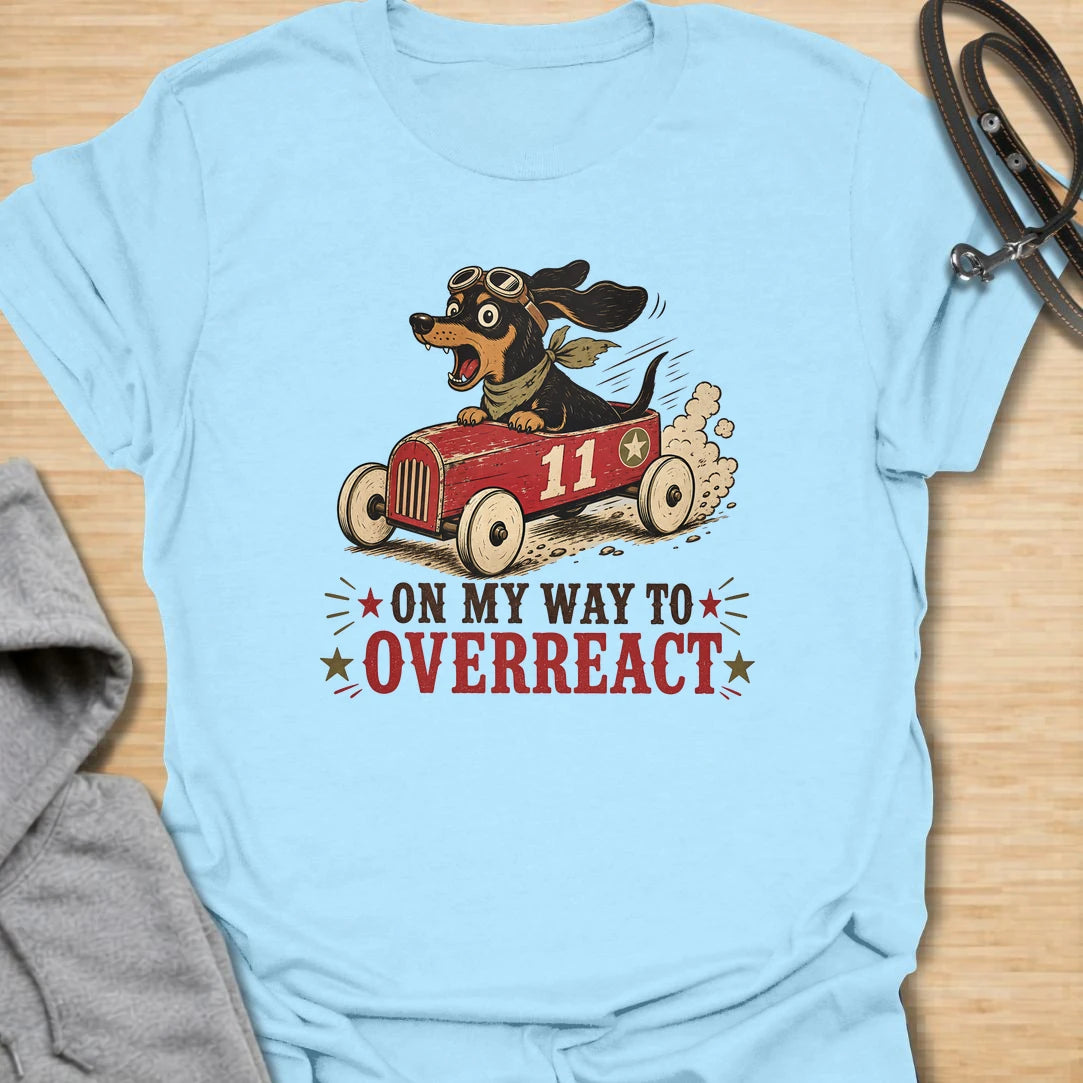 On My Way to Overreact t-shirt for dachshund lovers who know their little dog brings maximum drama to every situation. This funny vintage design features a chaotic wiener dog speeding along in a red racer car with bold retro lettering and classic doxie personality. Perfect for dachshund moms, doxie dads, sausage dog owners, and anyone who loves dramatic little dogs with big opinions.