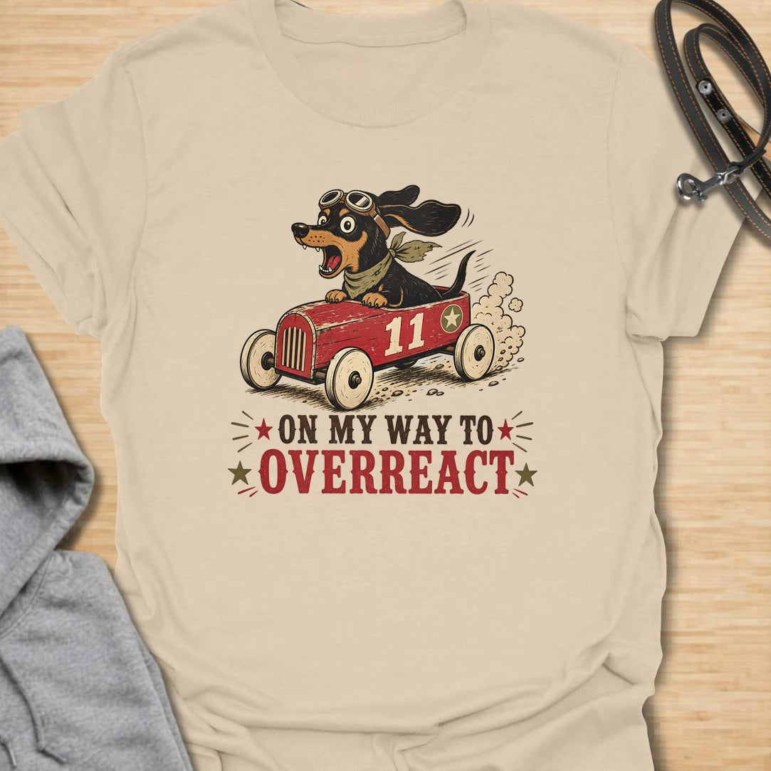 On My Way to Overreact t-shirt for dachshund lovers who know their little dog brings maximum drama to every situation. This funny vintage design features a chaotic wiener dog speeding along in a red racer car with bold retro lettering and classic doxie personality. Perfect for dachshund moms, doxie dads, sausage dog owners, and anyone who loves dramatic little dogs with big opinions.