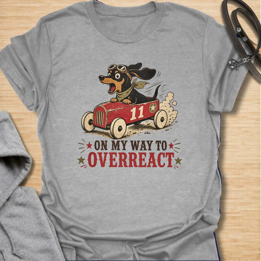 On My Way to Overreact t-shirt for dachshund lovers who know their little dog brings maximum drama to every situation. This funny vintage design features a chaotic wiener dog speeding along in a red racer car with bold retro lettering and classic doxie personality. Perfect for dachshund moms, doxie dads, sausage dog owners, and anyone who loves dramatic little dogs with big opinions.