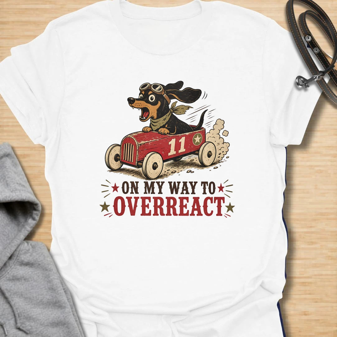 On My Way to Overreact t-shirt for dachshund lovers who know their little dog brings maximum drama to every situation. This funny vintage design features a chaotic wiener dog speeding along in a red racer car with bold retro lettering and classic doxie personality. Perfect for dachshund moms, doxie dads, sausage dog owners, and anyone who loves dramatic little dogs with big opinions.