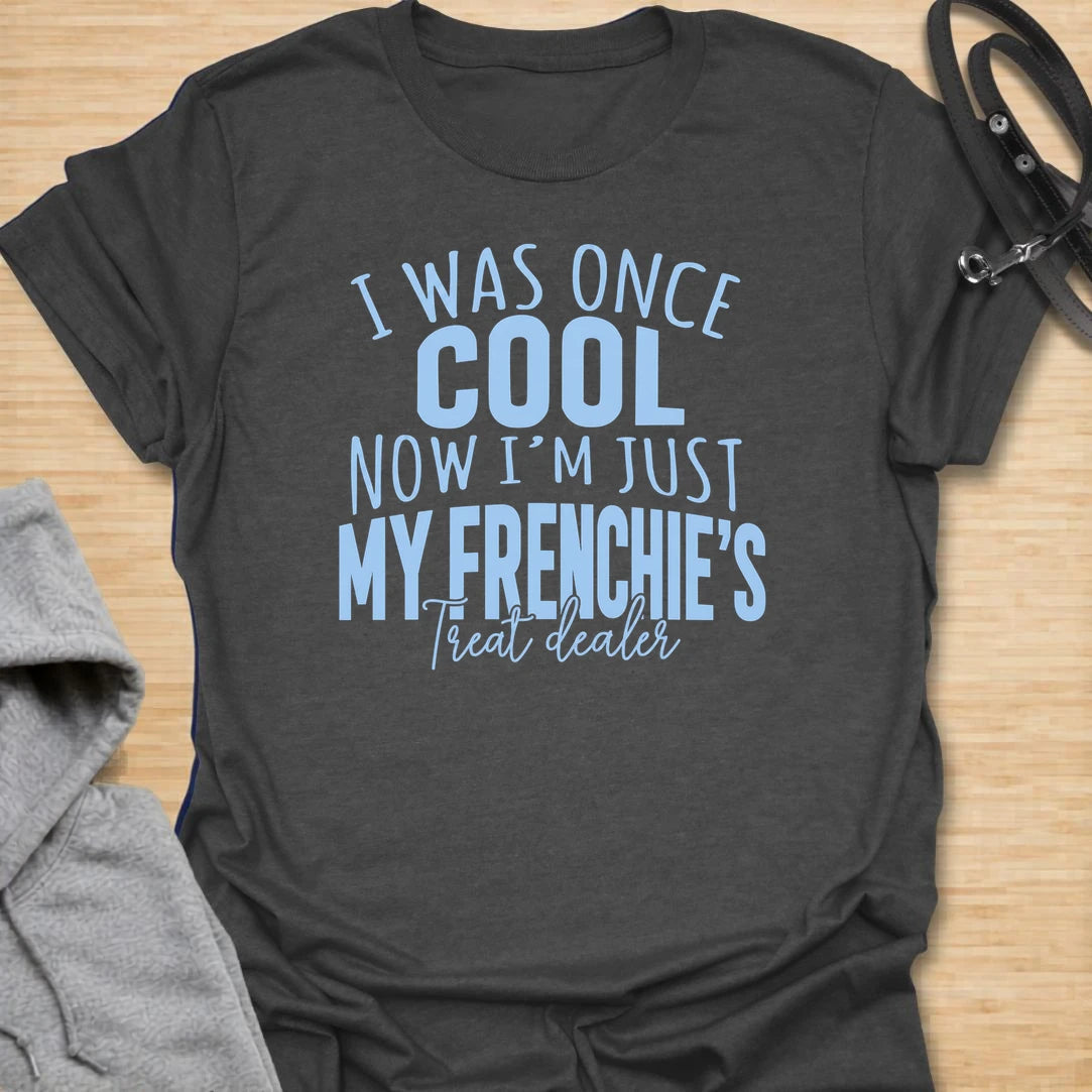This I Was Once Cool Now I’m Just My Frenchie’s Treat Dealer t-shirt is made for French Bulldog lovers who know their little dog has completely taken over their priorities. Featuring bold mixed typography and a funny treat-dealer message, this design has a relatable dog-parent feel that Frenchie owners will instantly understand. Perfect for Frenchie moms, Frenchie dads, French Bulldog owners, rescue dog lovers, and anyone whose pockets are basically full of dog treats now.