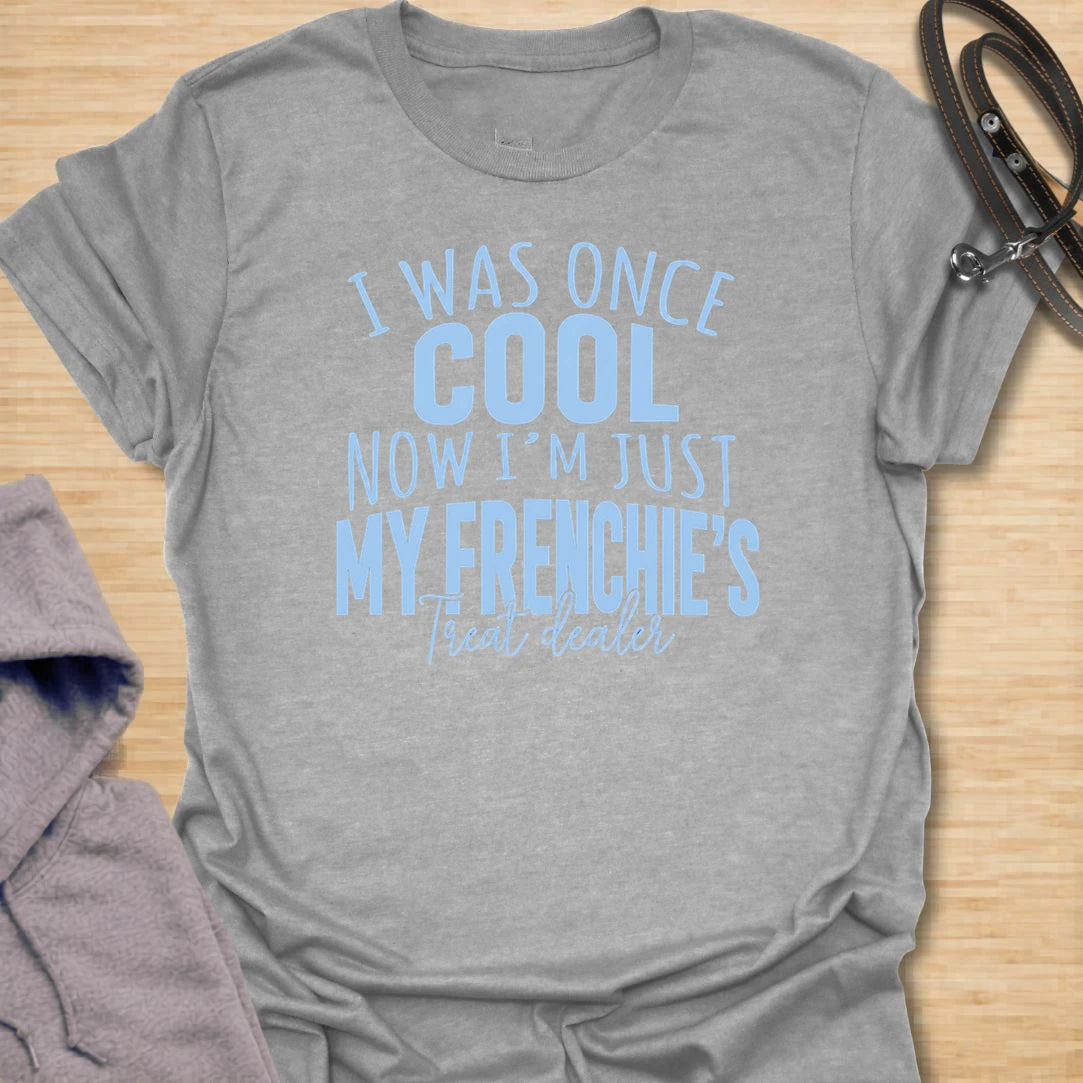 This I Was Once Cool Now I’m Just My Frenchie’s Treat Dealer t-shirt is made for French Bulldog lovers who know their little dog has completely taken over their priorities. Featuring bold mixed typography and a funny treat-dealer message, this design has a relatable dog-parent feel that Frenchie owners will instantly understand. Perfect for Frenchie moms, Frenchie dads, French Bulldog owners, rescue dog lovers, and anyone whose pockets are basically full of dog treats now.