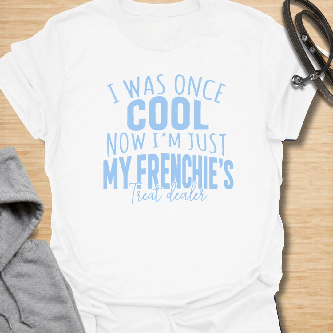 This I Was Once Cool Now I’m Just My Frenchie’s Treat Dealer t-shirt is made for French Bulldog lovers who know their little dog has completely taken over their priorities. Featuring bold mixed typography and a funny treat-dealer message, this design has a relatable dog-parent feel that Frenchie owners will instantly understand. Perfect for Frenchie moms, Frenchie dads, French Bulldog owners, rescue dog lovers, and anyone whose pockets are basically full of dog treats now.