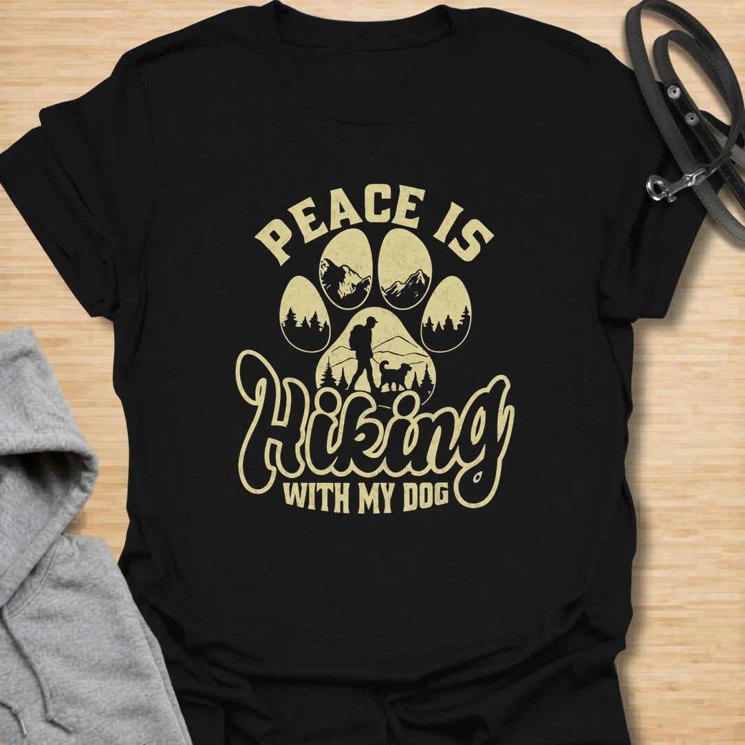 This peace hiking with my dog t-shirt is perfect for anyone who finds calm on the trail with their four-legged best friend. The paw print, mountain, forest, and hiking silhouette create a peaceful outdoor dog lover design. It is ideal for hikers, campers, dog moms, dog dads, and nature lovers who take their pets on every adventure. A great casual shirt for trail days, road trips, camping weekends, or gifting to an outdoorsy dog person.
