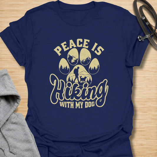 This peace hiking with my dog t-shirt is perfect for anyone who finds calm on the trail with their four-legged best friend. The paw print, mountain, forest, and hiking silhouette create a peaceful outdoor dog lover design. It is ideal for hikers, campers, dog moms, dog dads, and nature lovers who take their pets on every adventure. A great casual shirt for trail days, road trips, camping weekends, or gifting to an outdoorsy dog person.