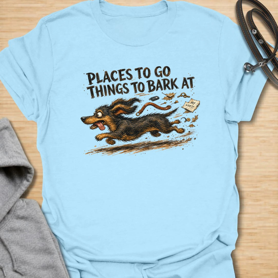 A chaotic dachshund T-shirt for little dogs with busy schedules and plenty of opinions. The energetic artwork captures a determined sausage dog racing toward its next completely unnecessary barking appointment. A funny gift for dachshund moms, dachshund dads, and anyone living with a tiny four-legged troublemaker.