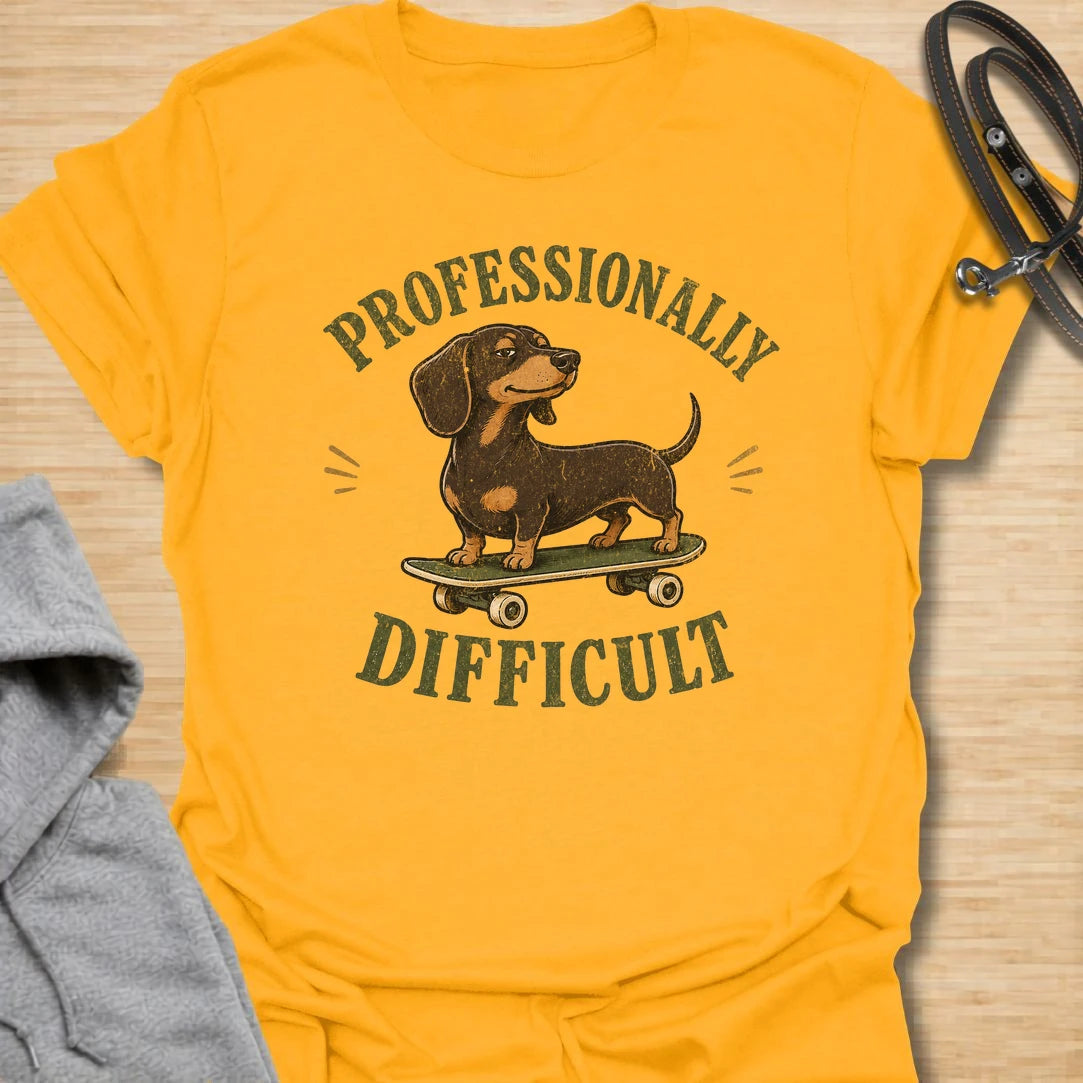 This Professionally Difficult t-shirt is made for dachshund lovers who know their little long dog has turned stubbornness into an art form. Featuring a smug dachshund standing on a skateboard with bold vintage-style lettering, this design has a funny breed-specific attitude. Perfect for dachshund moms, dachshund dads, wiener dog fans, rescue dog lovers, and anyone whose doxie is adorable but absolutely not easy.