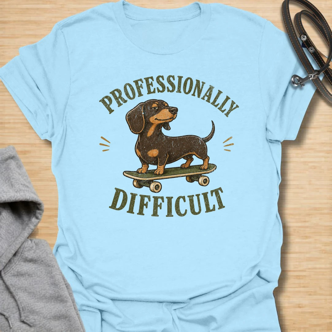 This Professionally Difficult t-shirt is made for dachshund lovers who know their little long dog has turned stubbornness into an art form. Featuring a smug dachshund standing on a skateboard with bold vintage-style lettering, this design has a funny breed-specific attitude. Perfect for dachshund moms, dachshund dads, wiener dog fans, rescue dog lovers, and anyone whose doxie is adorable but absolutely not easy.