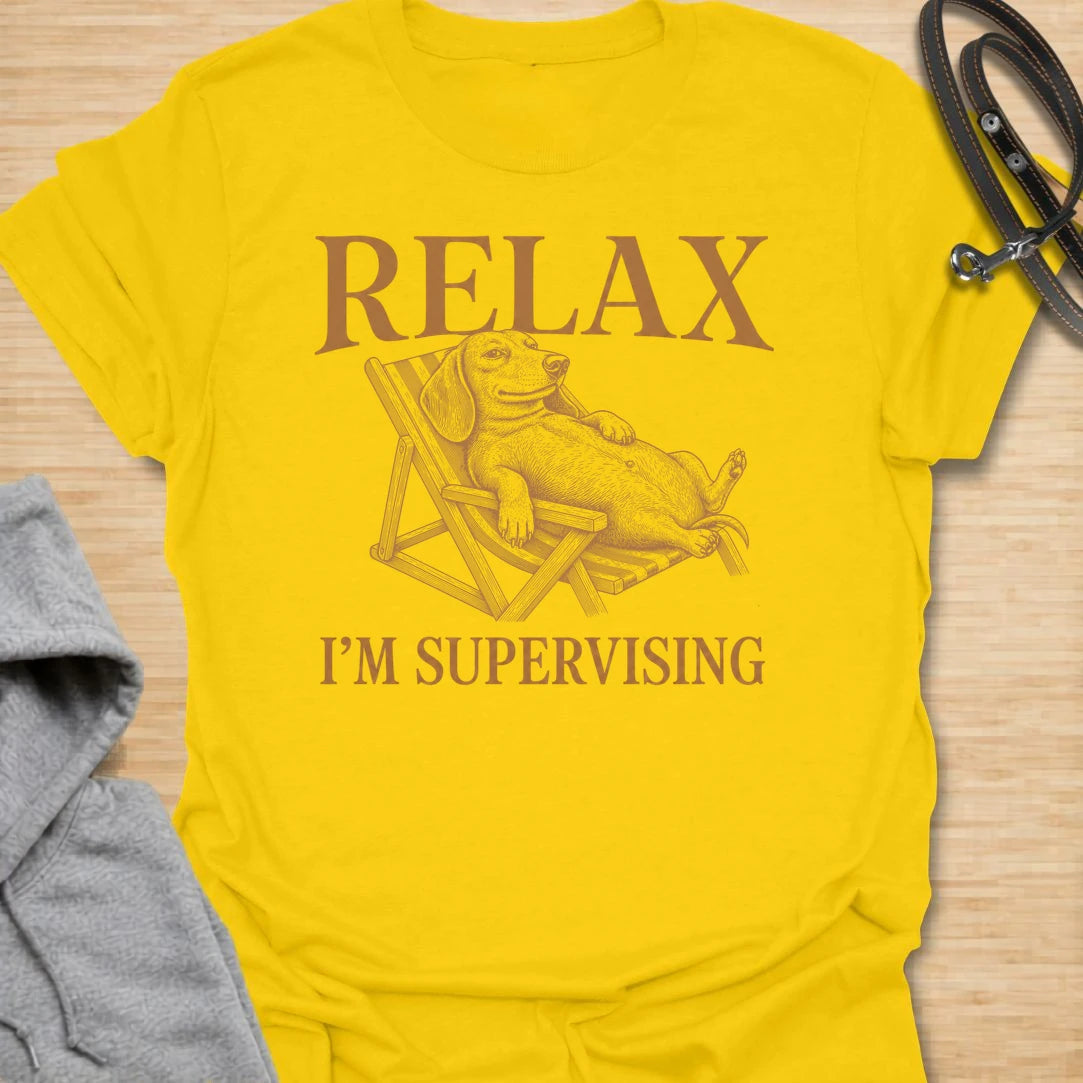 Relax I’m Supervising t-shirt for dachshund lovers who know their dog is always watching, judging, and doing absolutely no actual work. The vintage-style dachshund lounging in a chair gives the design a funny, laid-back look with classic doxie attitude. It is perfect for dachshund moms, doxie dads, and dog lovers whose pet believes supervision is a full-time job. A great casual shirt for anyone who loves lazy dog humor, stubborn dachshunds, and designs with a relaxed vintage feel.