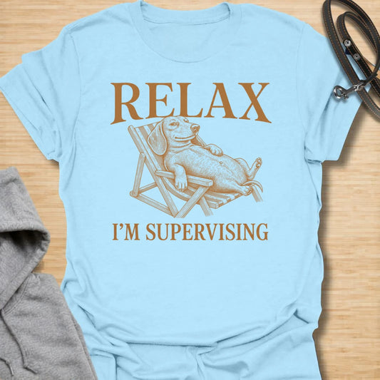 Relax I’m Supervising t-shirt for dachshund lovers who know their dog is always watching, judging, and doing absolutely no actual work. The vintage-style dachshund lounging in a chair gives the design a funny, laid-back look with classic doxie attitude. It is perfect for dachshund moms, doxie dads, and dog lovers whose pet believes supervision is a full-time job. A great casual shirt for anyone who loves lazy dog humor, stubborn dachshunds, and designs with a relaxed vintage feel.