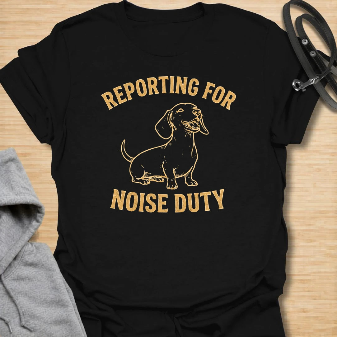 This Reporting For Noise Duty t-shirt is made for dachshund lovers who know their little long dog takes barking very seriously. Featuring a bold one-color dachshund illustration with strong simple lettering, this design has a funny breed-specific feel that doxie owners will instantly understand. Perfect for dachshund moms, dachshund dads, wiener dog fans, rescue dog lovers, and anyone living with a tiny self-appointed alarm system.