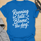 Funny dog lover t-shirt featuring the phrase “Running late. Blame the dog.” A perfect tee for dog moms, dog dads, rescue dog owners, and pet parents who know dogs always come first.