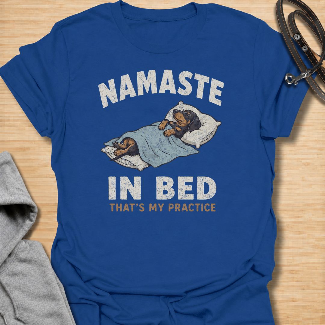 Celebrate the dachshund approach to yoga with this funny “Namaste in Bed” T-shirt. Featuring a cozy sausage dog tucked beneath the blankets with the phrase “That’s My Practice,” it is perfect for dachshund moms, dog dads, homebodies, and yoga lovers. A playful gift for anyone who prefers relaxation, naps, and staying comfortably in bed.