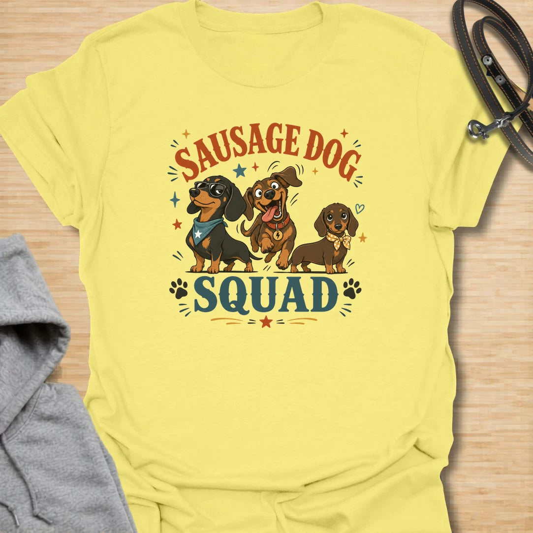 Sausage Dog Squad t-shirt for dachshund lovers who know every doxie has a very different personality. The playful design features three funny dachshunds with big expressions, bold lettering, and plenty of chaotic little-dog charm. It is perfect for dachshund moms, doxie dads, wiener dog fans, and anyone who loves breed-specific dog humor. A fun gift for dachshund owners whose tiny long dogs act like the whole neighborhood belongs to them.