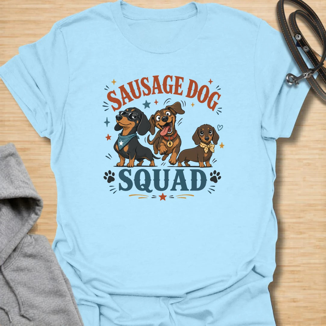 Sausage Dog Squad t-shirt for dachshund lovers who know every doxie has a very different personality. The playful design features three funny dachshunds with big expressions, bold lettering, and plenty of chaotic little-dog charm. It is perfect for dachshund moms, doxie dads, wiener dog fans, and anyone who loves breed-specific dog humor. A fun gift for dachshund owners whose tiny long dogs act like the whole neighborhood belongs to them.