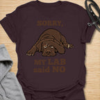 This Sorry, My Lab Said No t-shirt is made for Labrador lovers who know their dog’s opinion carries serious weight. Featuring a grumpy chocolate Lab lying down with bold playful text, this design has a funny, stubborn-dog attitude that Labrador owners will instantly understand. Perfect for Lab moms, Lab dads, chocolate Lab lovers, Labrador owners, rescue dog fans, and anyone who lets their dog make the final decision. Dark Chocolate