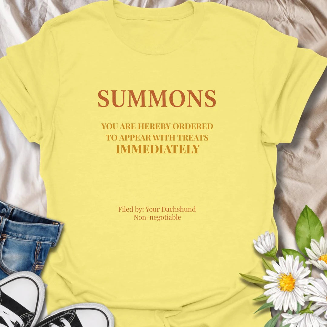 You have been officially ordered to appear with treats immediately, and your dachshund will accept no excuses. This funny legal-style dog T-shirt is made for owners familiar with non-negotiable snack demands. A clever gift for dachshund moms, dads, and anyone serving a tiny four-legged authority figure.