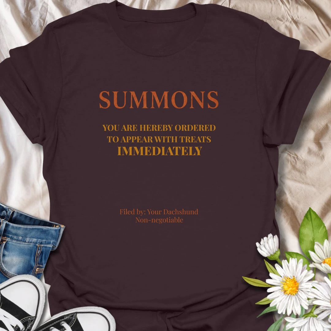 You have been officially ordered to appear with treats immediately, and your dachshund will accept no excuses. This funny legal-style dog T-shirt is made for owners familiar with non-negotiable snack demands. A clever gift for dachshund moms, dads, and anyone serving a tiny four-legged authority figure.