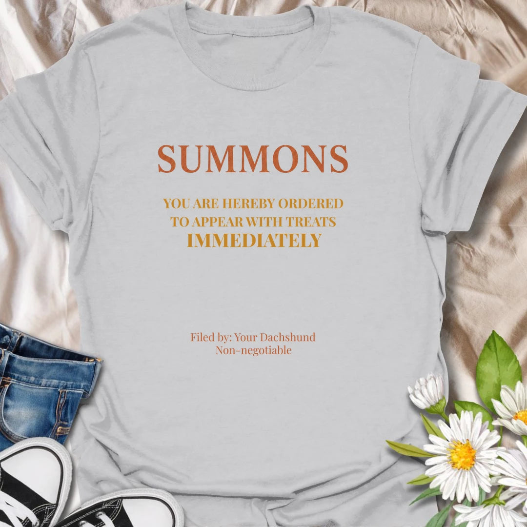You have been officially ordered to appear with treats immediately, and your dachshund will accept no excuses. This funny legal-style dog T-shirt is made for owners familiar with non-negotiable snack demands. A clever gift for dachshund moms, dads, and anyone serving a tiny four-legged authority figure.