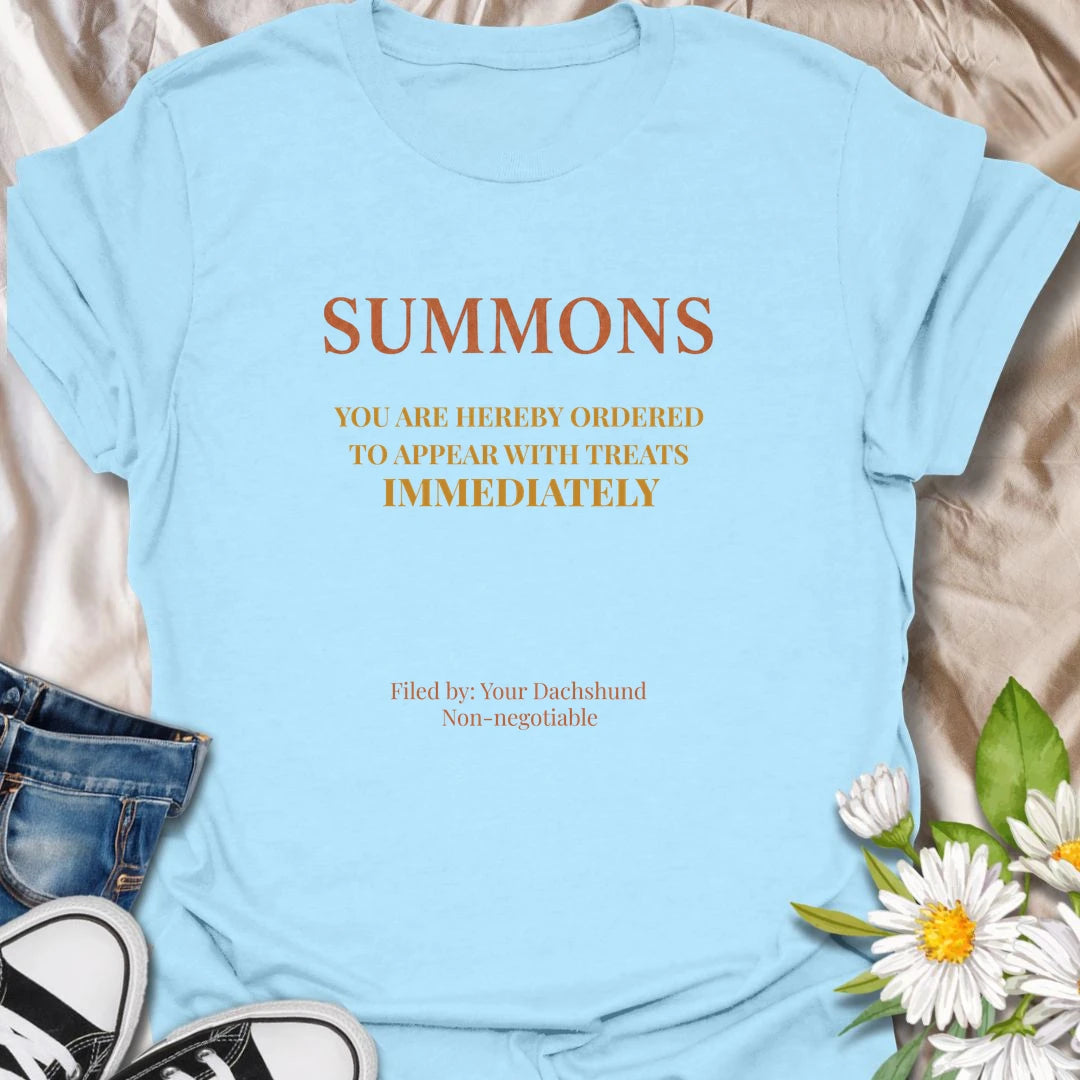 You have been officially ordered to appear with treats immediately, and your dachshund will accept no excuses. This funny legal-style dog T-shirt is made for owners familiar with non-negotiable snack demands. A clever gift for dachshund moms, dads, and anyone serving a tiny four-legged authority figure.