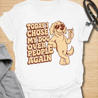 This Today I Chose My Dog Over People Again t-shirt is made for dog lovers who would rather hang out with their pup than deal with unnecessary social plans. Featuring a cool cartoon dog in sunglasses holding a drink, with bold retro lettering and a playful vintage vibe, this design is funny, snarky, and full of dog-parent attitude. Perfect for dog moms, dog dads, rescue dog owners, introverts, pet parents, and anyone who proudly chooses dogs over people. White