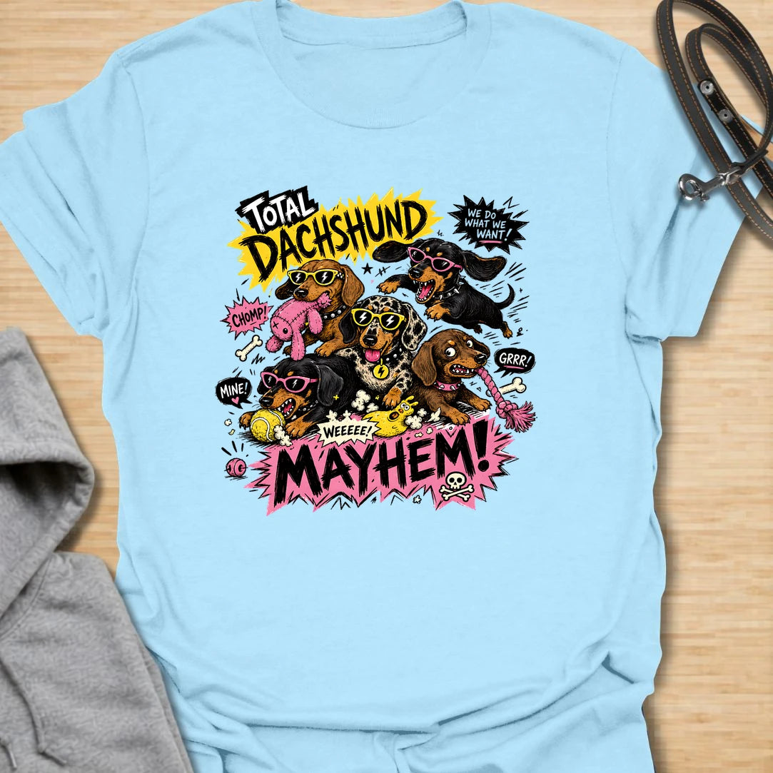 Dachshund Mayhem t-shirt for doxie lovers who live with tiny chaos, loud opinions, and nonstop sausage dog energy. This bold comic-style design features a wild pack of dachshunds causing total mayhem with toys, sunglasses, and attitude. Perfect for dachshund moms, multi-dog homes, and anyone who loves loud, funny dog designs.